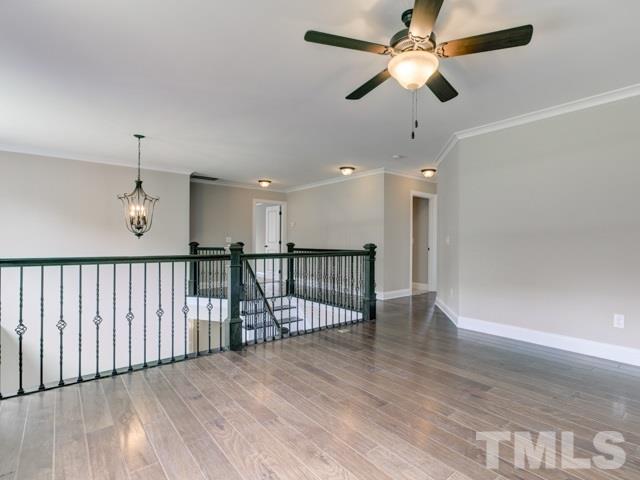 9814 Chris Drive Raleigh, NC 27603 - Photo 21 of 25 a view of a livingroom with a ceiling fan and wooden floor