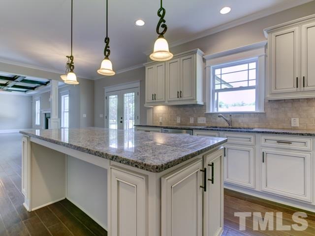 9814 Chris Drive Raleigh, NC 27603 - Photo 6 of 25 a kitchen with granite countertop a sink cabinets and window
