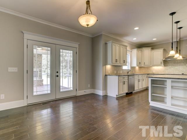 9814 Chris Drive Raleigh, NC 27603 - Photo 9 of 25 a kitchen with stainless steel appliances granite countertop a stove top oven a sink and a chandelier