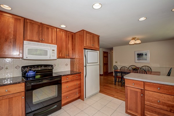 201 Davidson Road Boxborough, MA 01719 - Photo 4 of 30 a kitchen with stainless steel appliances granite countertop a stove a refrigerator and a microwave