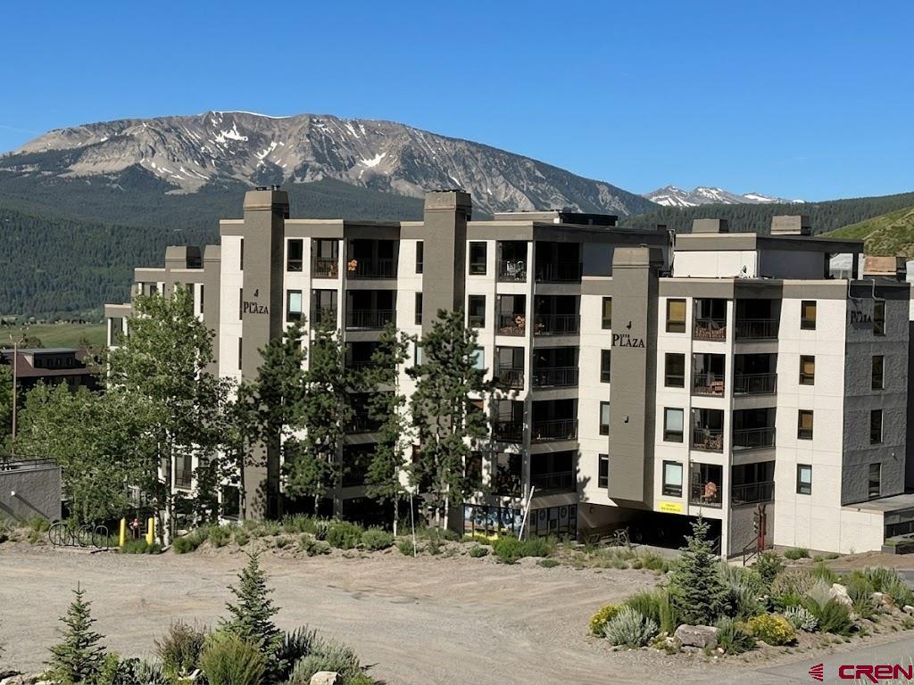11 Snowmass Road, Unit 337 Crested Butte, CO 81225 - Photo 5 of 35 a front view of a residential apartment building with a yard