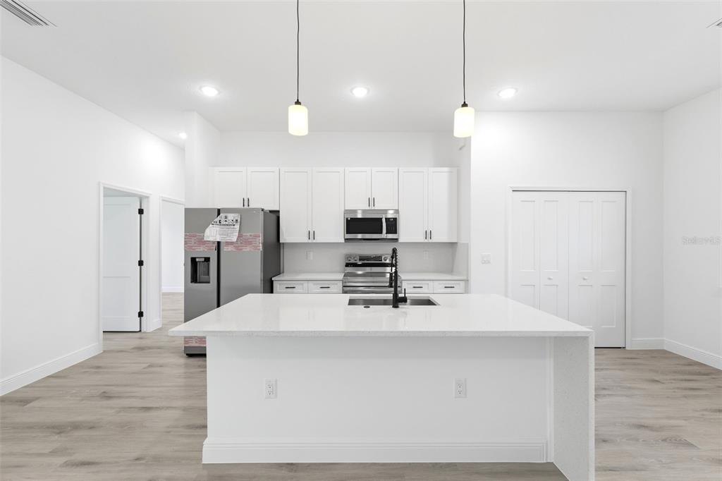 4510 Southwest 155th Street Ocala, FL 34473 - Photo 11 of 40 a kitchen with stainless steel appliances a refrigerator sink and microwave