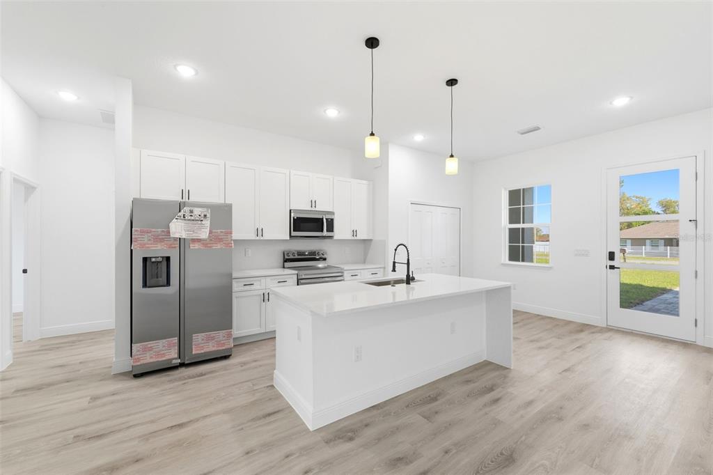 4510 Southwest 155th Street Ocala, FL 34473 - Photo 12 of 40 a view of kitchen with stainless steel appliances granite countertop a sink a refrigerator and a stove