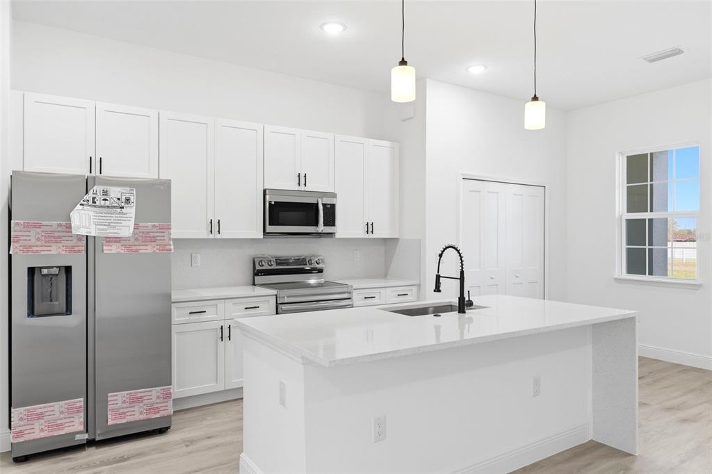 4510 Southwest 155th Street Ocala, FL 34473 - Photo 13 of 40 a kitchen with stainless steel appliances a refrigerator sink and microwave