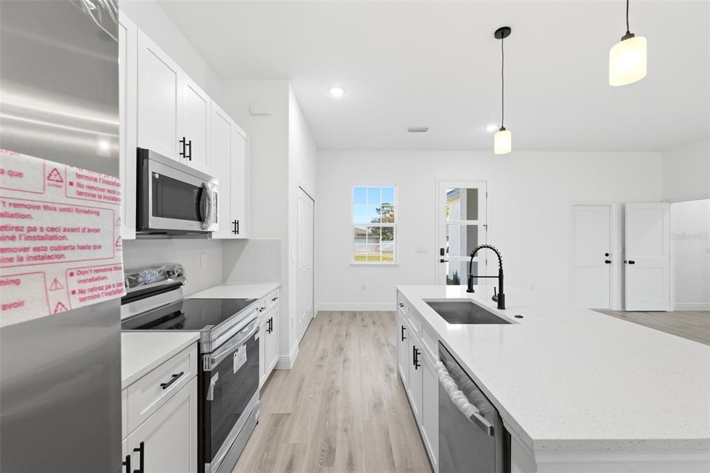 4510 Southwest 155th Street Ocala, FL 34473 - Photo 14 of 40 a kitchen with a sink appliances and cabinets