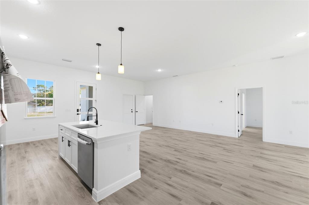 4510 Southwest 155th Street Ocala, FL 34473 - Photo 15 of 40 a view of a kitchen with a sink and wooden floor