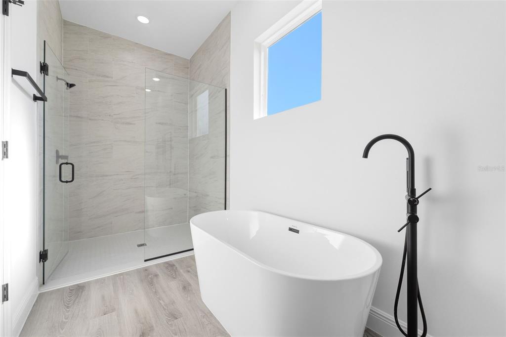 4510 Southwest 155th Street Ocala, FL 34473 - Photo 23 of 40 a bathroom with a white bath tub and shower