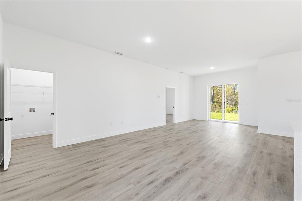 4510 Southwest 155th Street Ocala, FL 34473 - Photo 7 of 40 an empty room with wooden floor and windows