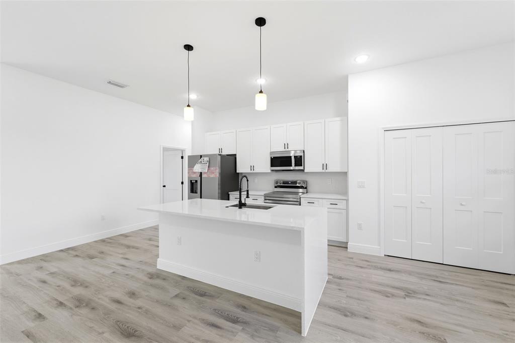4510 Southwest 155th Street Ocala, FL 34473 - Photo 9 of 40 a kitchen with stainless steel appliances a refrigerator sink and microwave