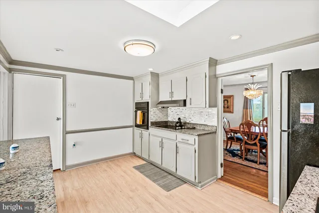 a view of a dining room with furniture wooden floor and chandelier