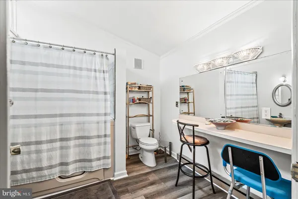 a bathroom with a sink mirror and tub