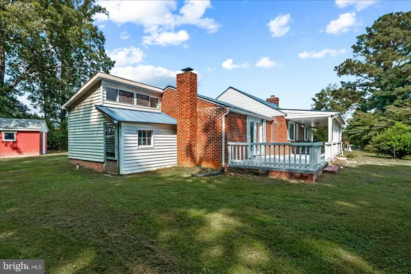 a view of a house with a yard and a porch