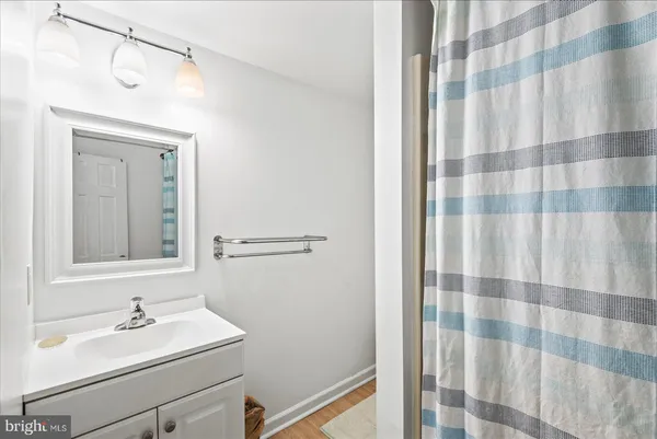 a bathroom with a shower and a glass door