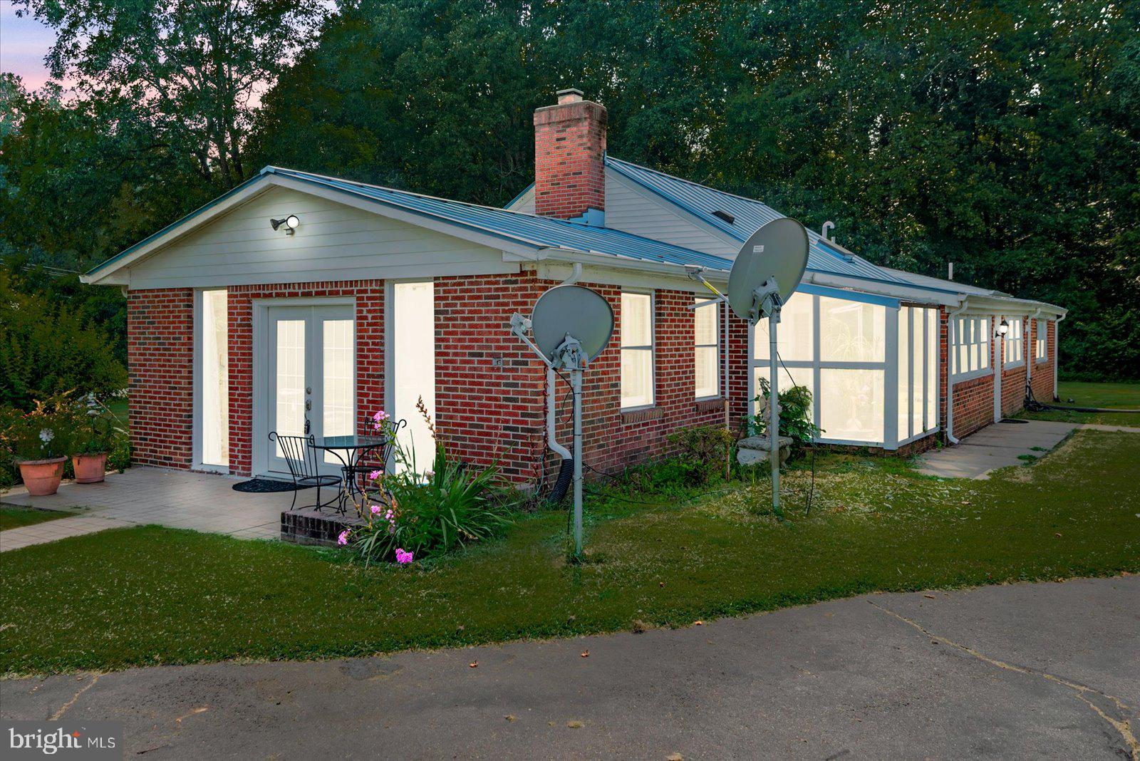 2931 Vawter Corner Road Louisa, VA 23093 - Photo 26 of 47 a front view of a house with a yard and garage