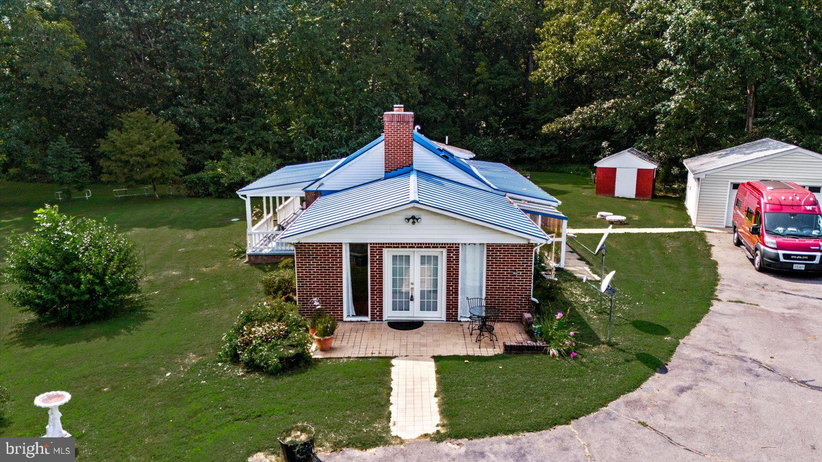 2931 Vawter Corner Road Louisa, VA 23093 - Photo 35 of 47 a front view of a house with a yard table and chairs