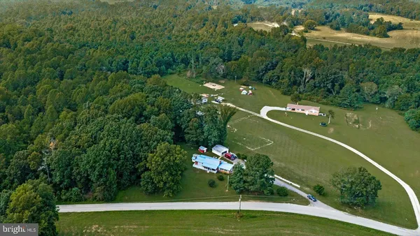 an aerial view of a house a yard and lake view