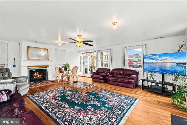 a living room with furniture a rug and a fireplace
