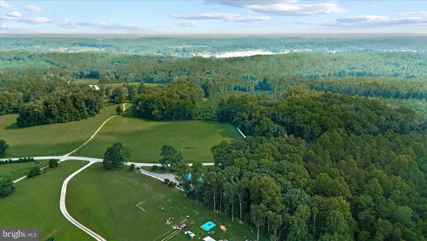 a view of a green field with lots of trees