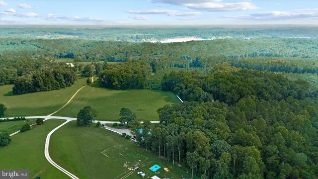 a view of a green field with lots of trees