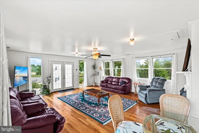 a living room with furniture and large windows