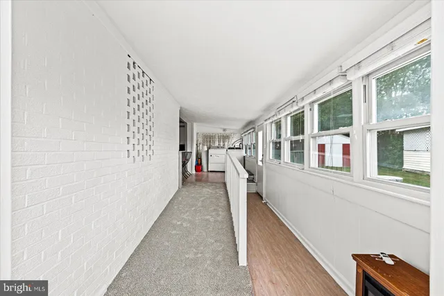 a view of an entryway with wooden floor
