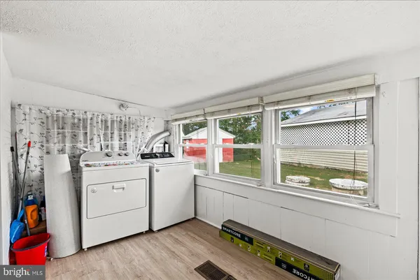 a kitchen with stainless steel appliances granite countertop a sink refrigerator and cabinets