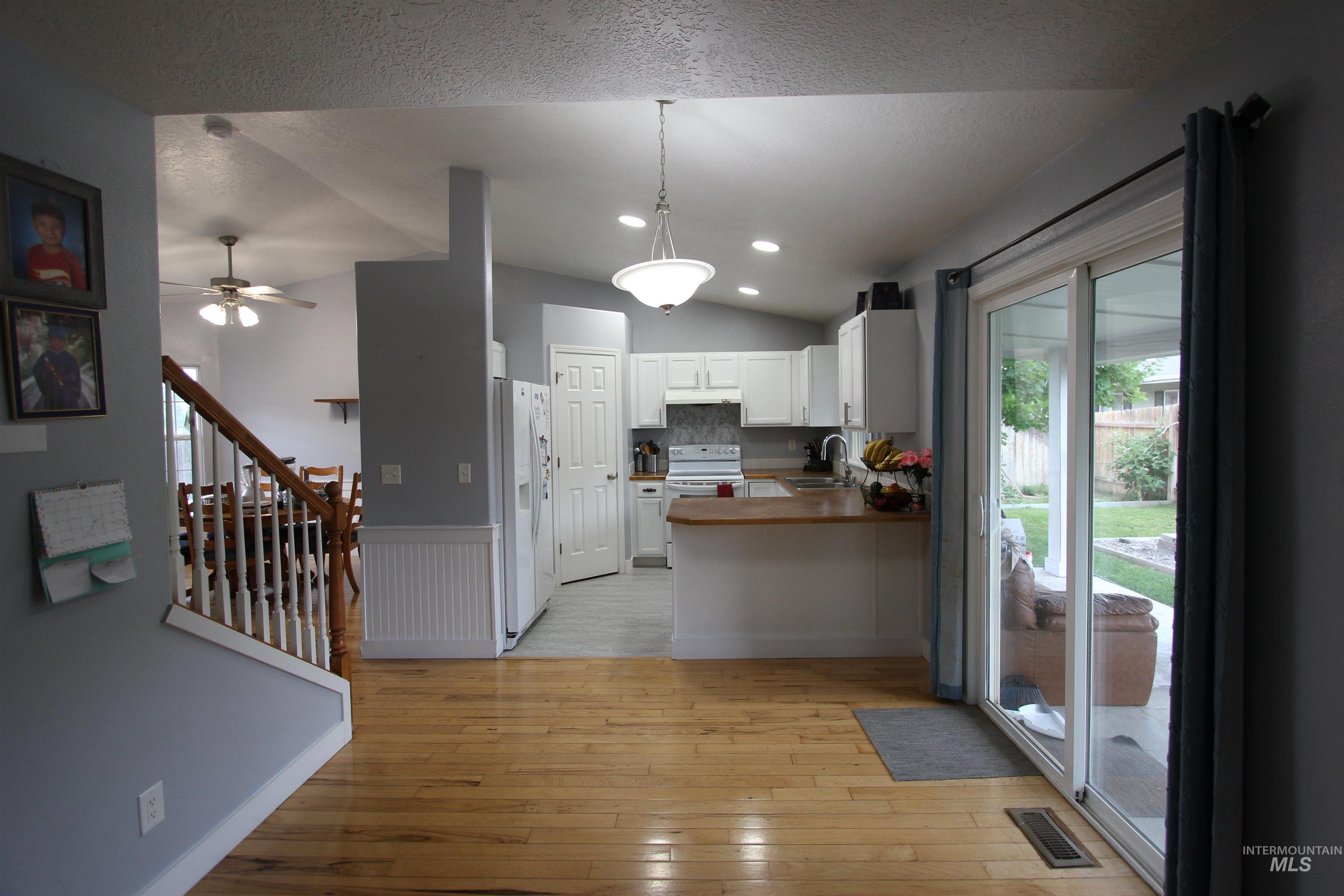 4816 Kadie Street Caldwell, ID 83607 - Photo 10 of 23 Kitchen featuring white cabinetry, light wood-finish countertops, and a white tile backsplash