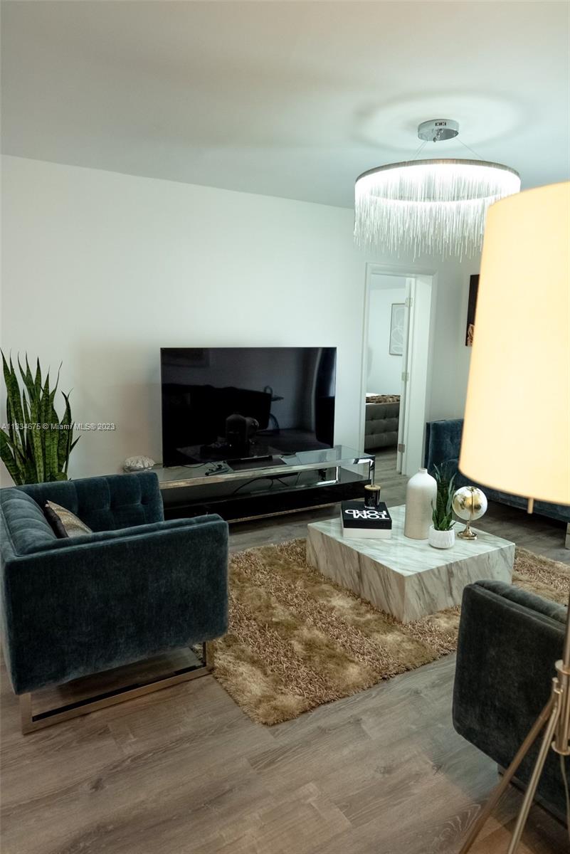 520 Northwest 45th Street, Unit 1 Miami, FL 33127 - Photo 3 of 7 a living room with furniture and a fireplace