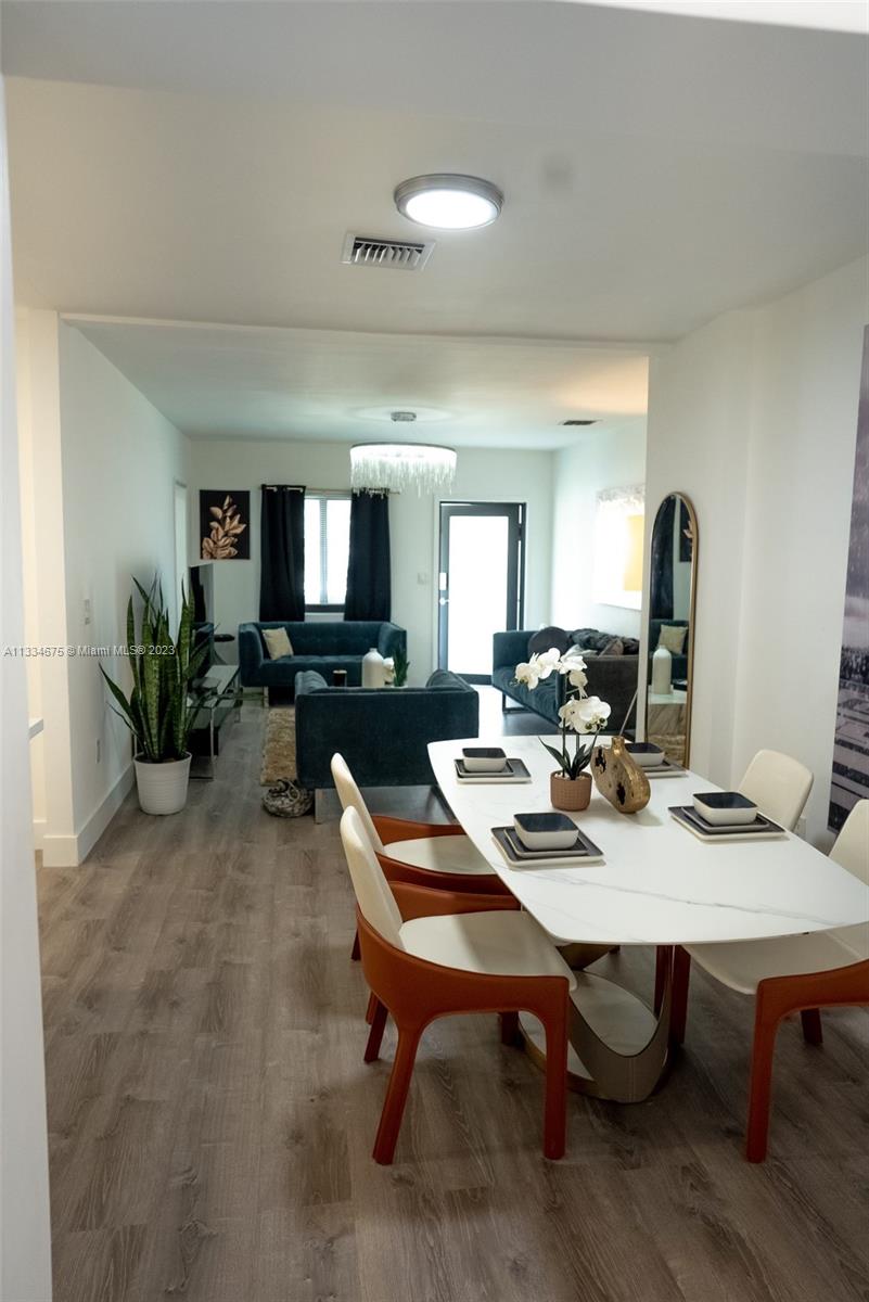 520 Northwest 45th Street, Unit 1 Miami, FL 33127 - Photo 4 of 7 a view of a dining room with furniture