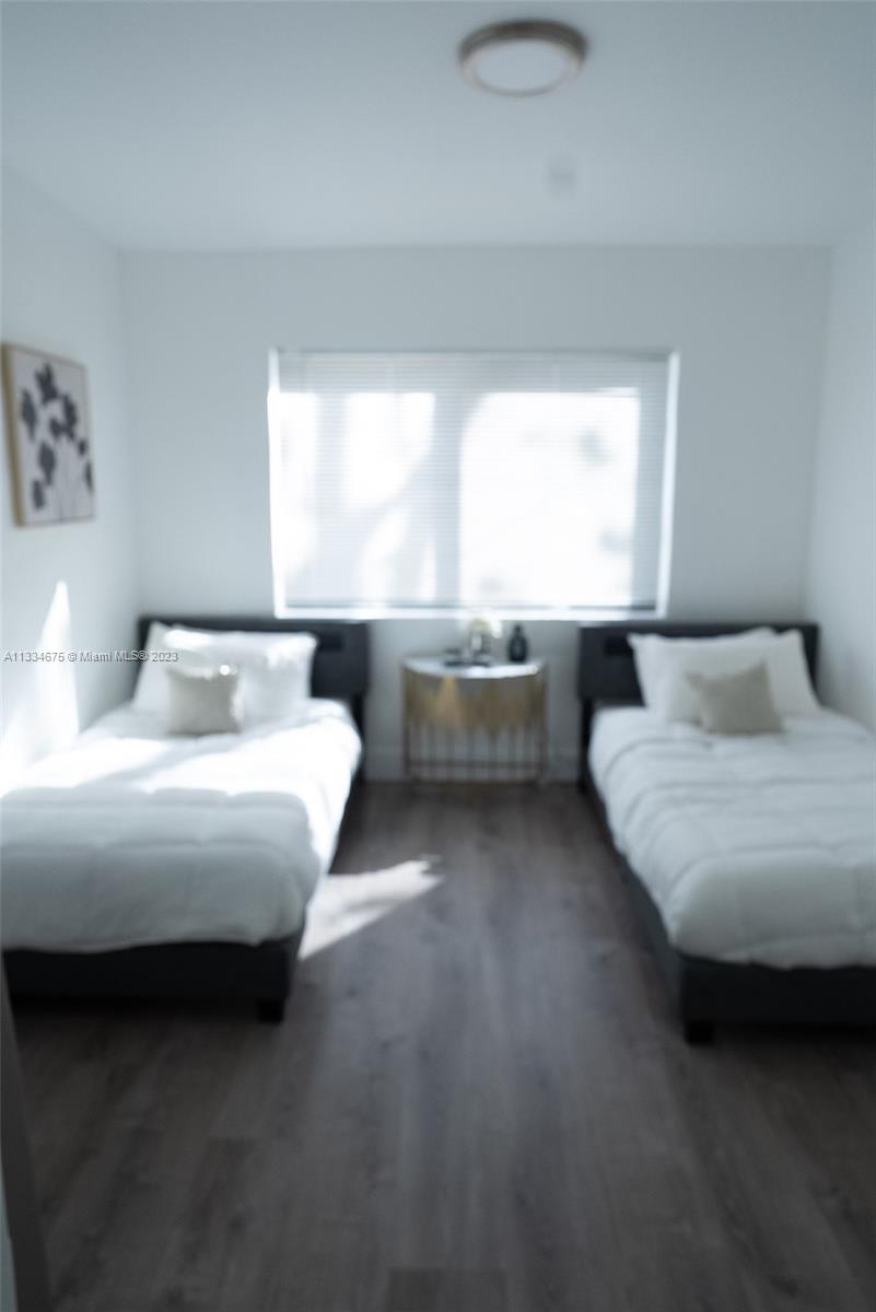 520 Northwest 45th Street, Unit 1 Miami, FL 33127 - Photo 6 of 7 a bedroom with a bed and a window