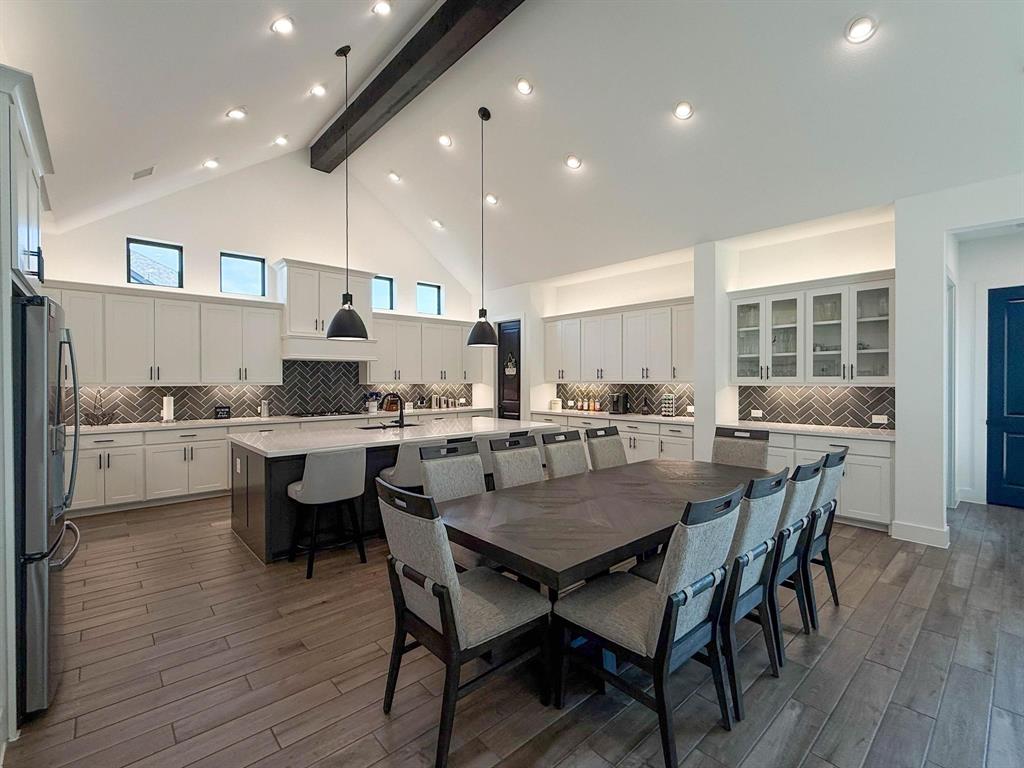 1620 Ripasso Way McLendon-Chisholm, TX 75032 - Photo 16 of 40 a kitchen with a dining table chairs and wooden floor