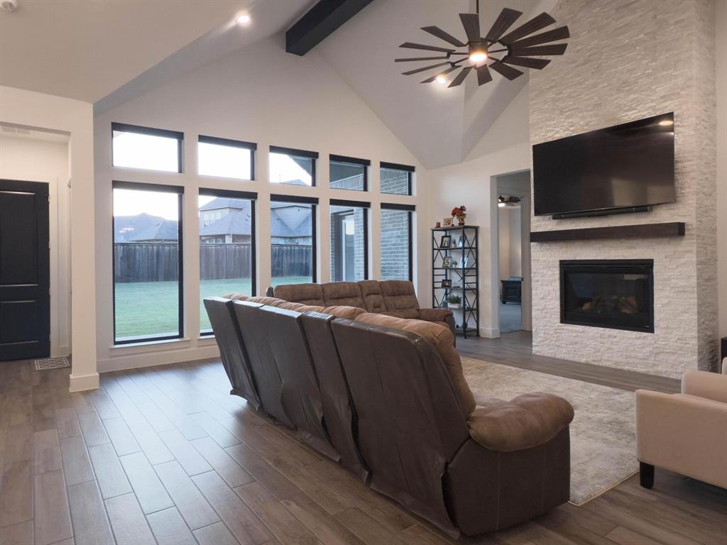 1620 Ripasso Way McLendon-Chisholm, TX 75032 - Photo 25 of 40 a living room with furniture a flat screen tv and a fireplace