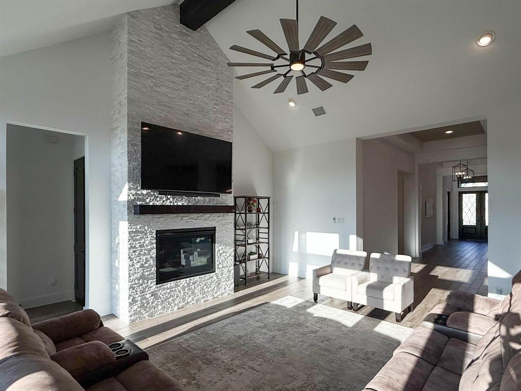 1620 Ripasso Way McLendon-Chisholm, TX 75032 - Photo 31 of 40 a living room with furniture a fireplace and a flat screen tv