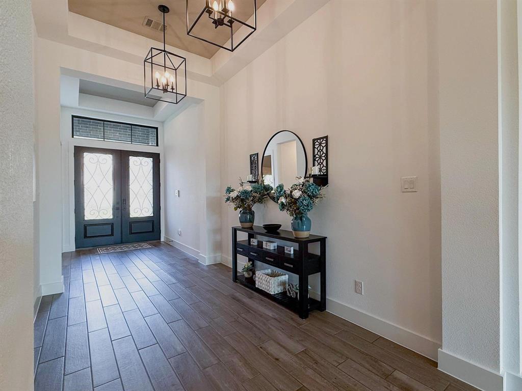 1620 Ripasso Way McLendon-Chisholm, TX 75032 - Photo 7 of 40 a view of a room with wooden floor and windows
