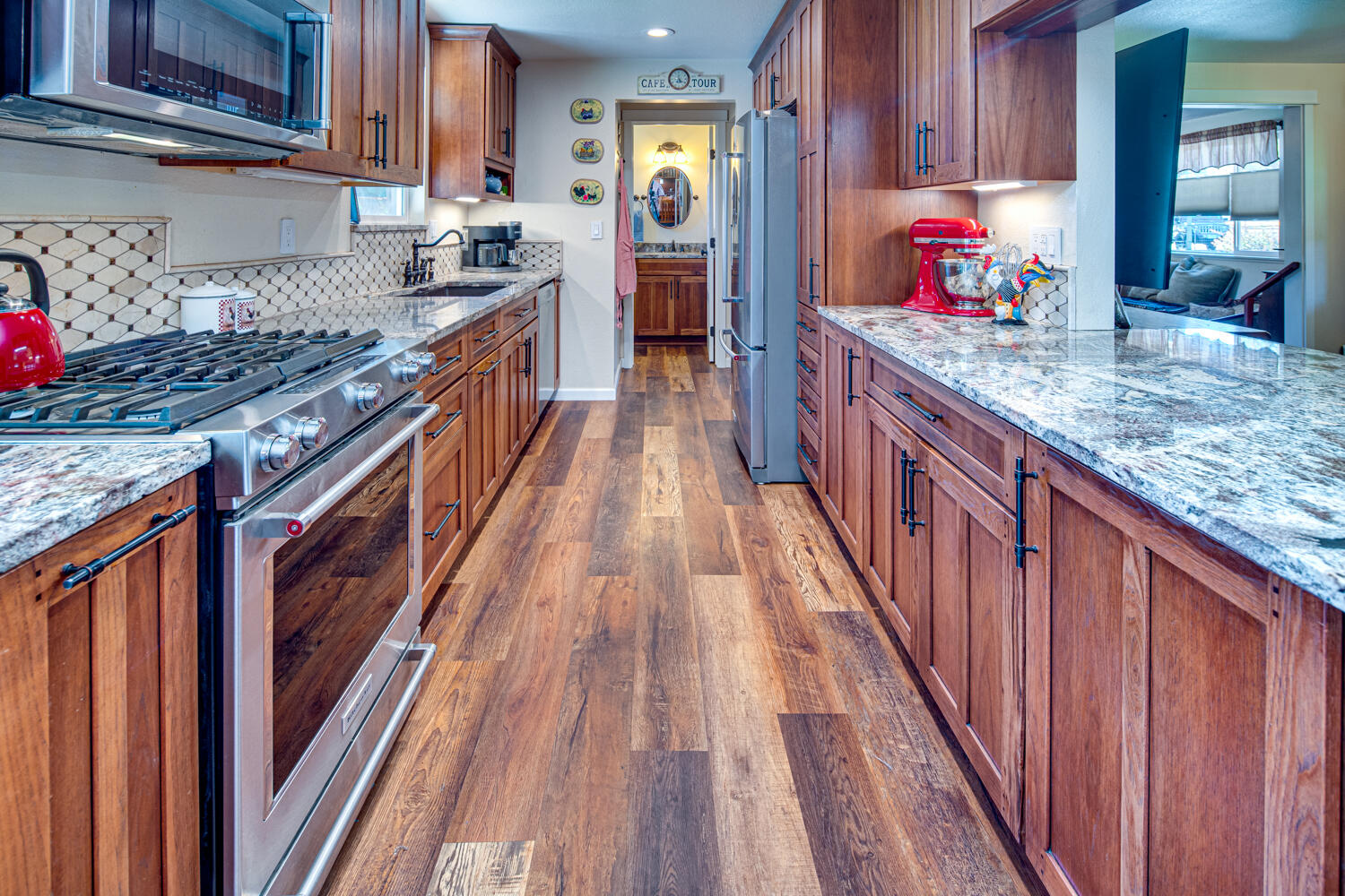 2218 Southwest 79th Street Redmond, OR 97756 - Photo 12 of 54 a kitchen with granite countertop lots of wooden cabinets