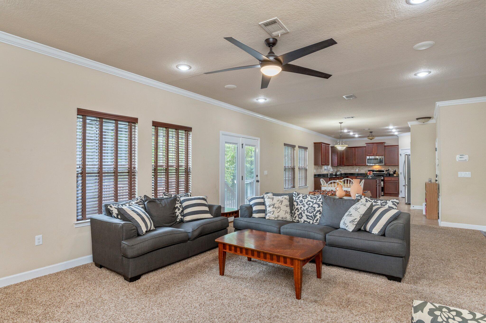 4558 Hermosa Road Crestview, FL 32539 - Photo 14 of 48 a living room with furniture and a ceiling fan
