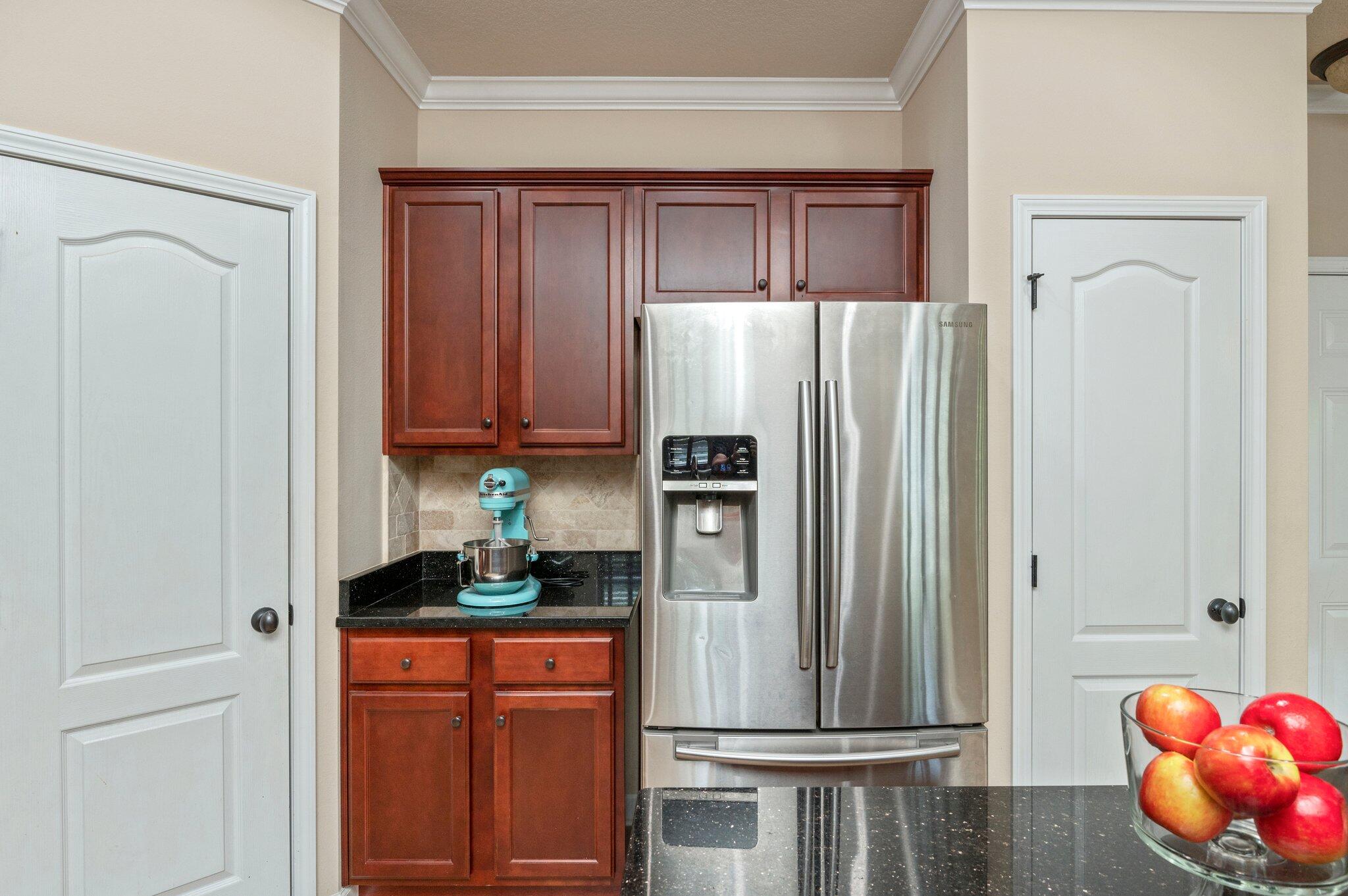 4558 Hermosa Road Crestview, FL 32539 - Photo 19 of 48 a kitchen with stainless steel appliances granite countertop a refrigerator and a stove top oven
