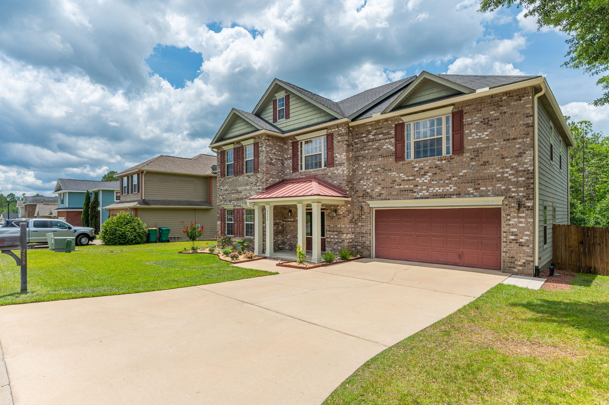 4558 Hermosa Road Crestview, FL 32539 - Photo 2 of 48 a front view of a house with a yard and garage