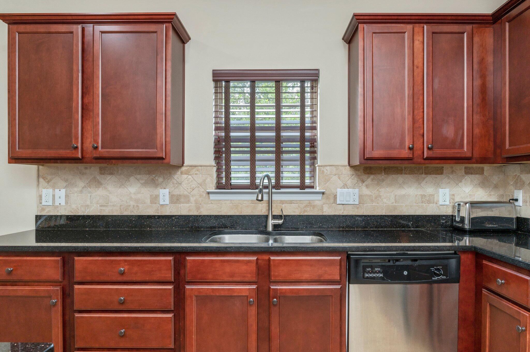 4558 Hermosa Road Crestview, FL 32539 - Photo 21 of 48 a kitchen with granite countertop cabinets and window