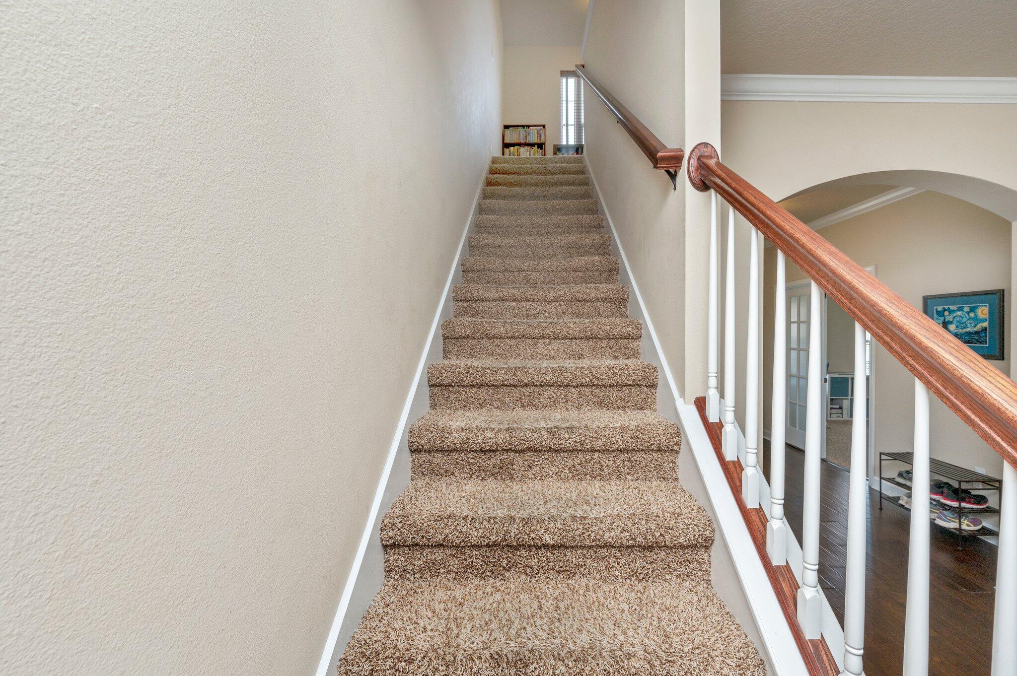 4558 Hermosa Road Crestview, FL 32539 - Photo 23 of 48 a view of staircase with wooden floor and white walls