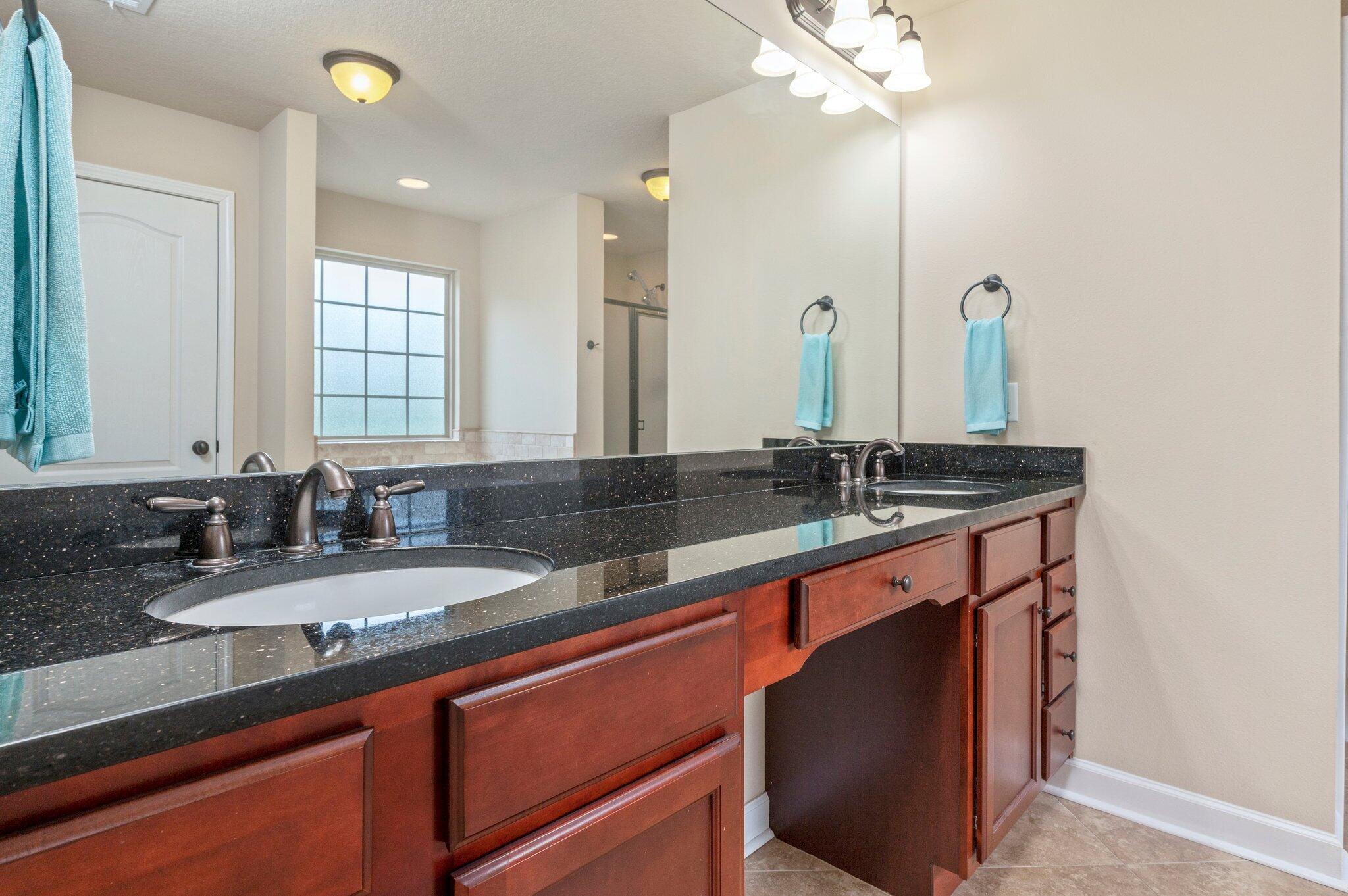 4558 Hermosa Road Crestview, FL 32539 - Photo 27 of 48 a bathroom with double sink and a mirror