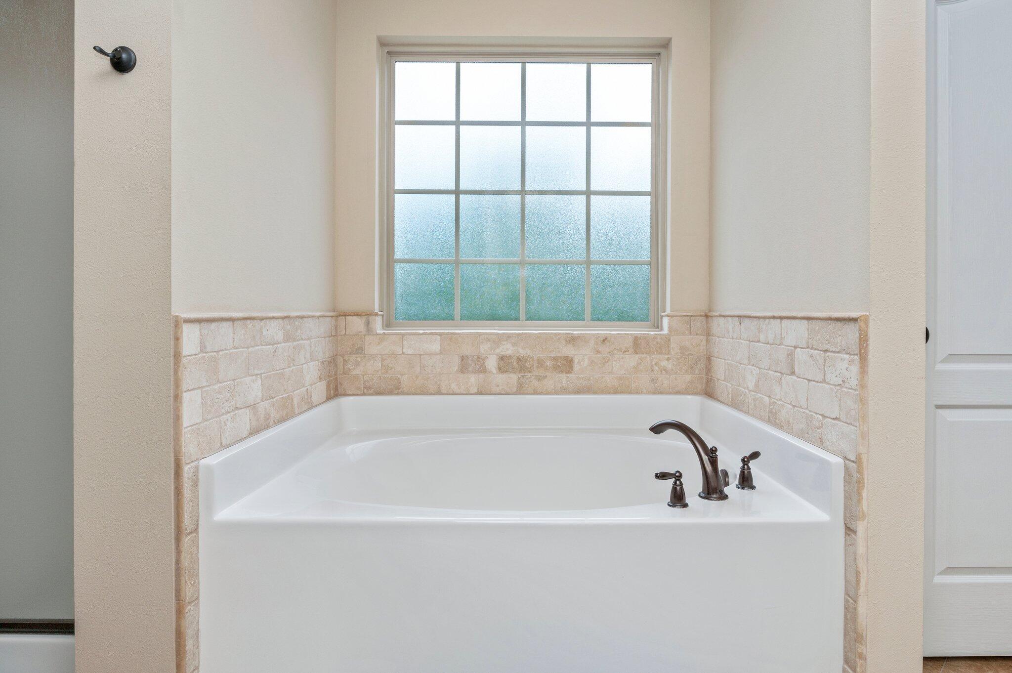 4558 Hermosa Road Crestview, FL 32539 - Photo 28 of 48 a white bath tub sitting next to a window