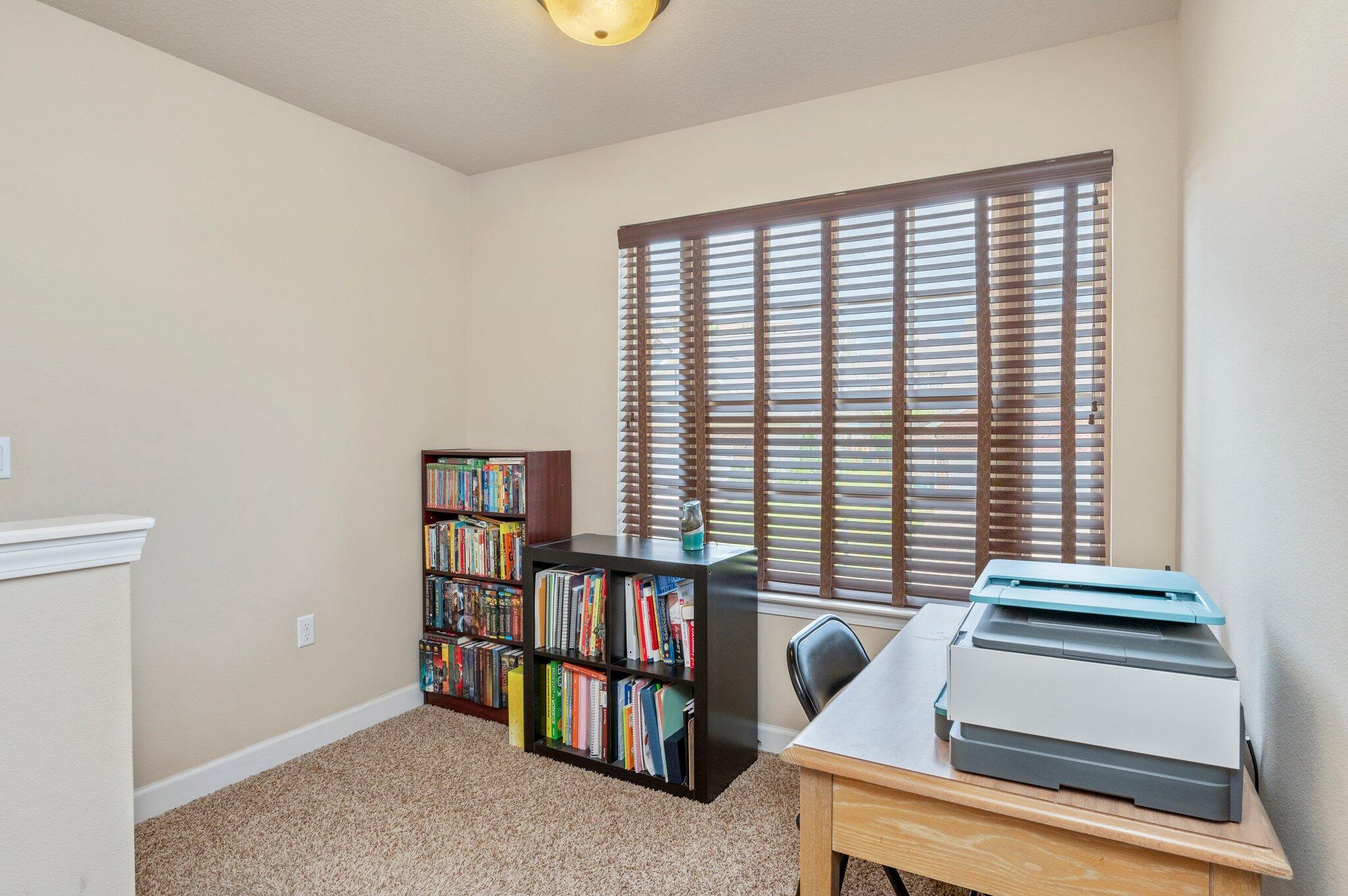 4558 Hermosa Road Crestview, FL 32539 - Photo 32 of 48 a living room with furniture and a book shelf