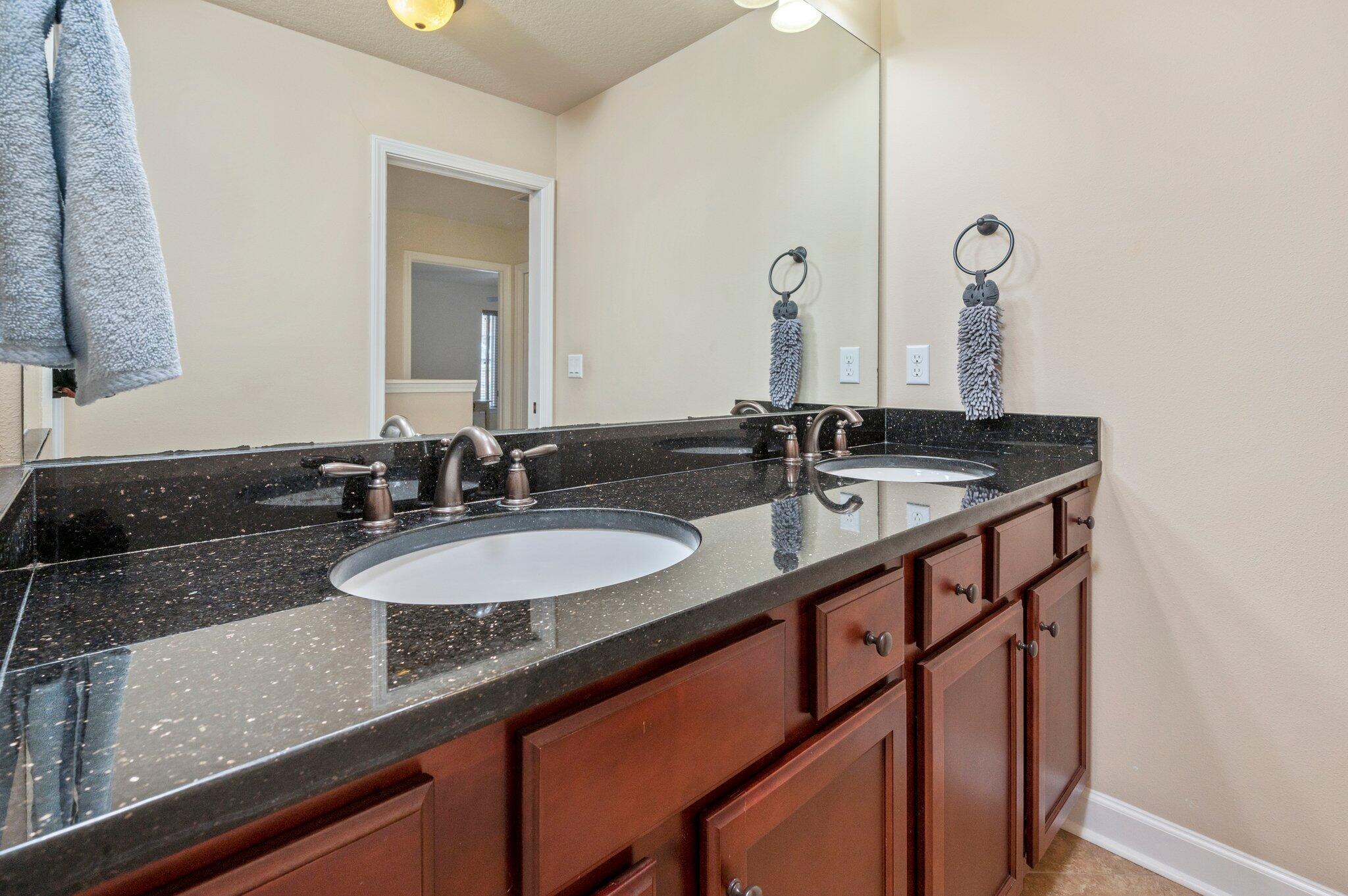 4558 Hermosa Road Crestview, FL 32539 - Photo 35 of 48 a bathroom with double sink and a mirror