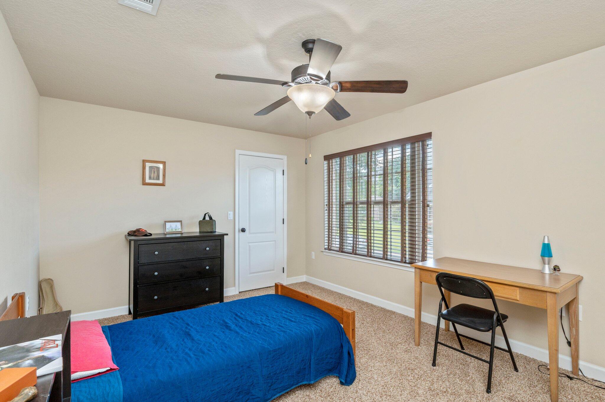 4558 Hermosa Road Crestview, FL 32539 - Photo 37 of 48 a bedroom with a bed and a desk