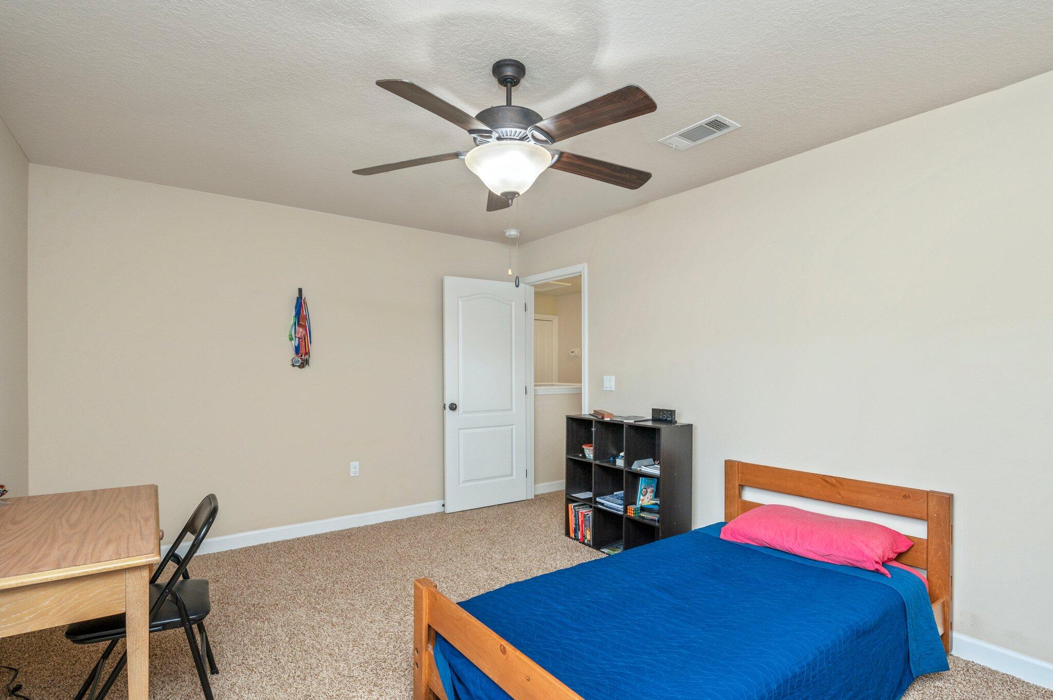 4558 Hermosa Road Crestview, FL 32539 - Photo 38 of 48 a bedroom with a bed and a chandelier