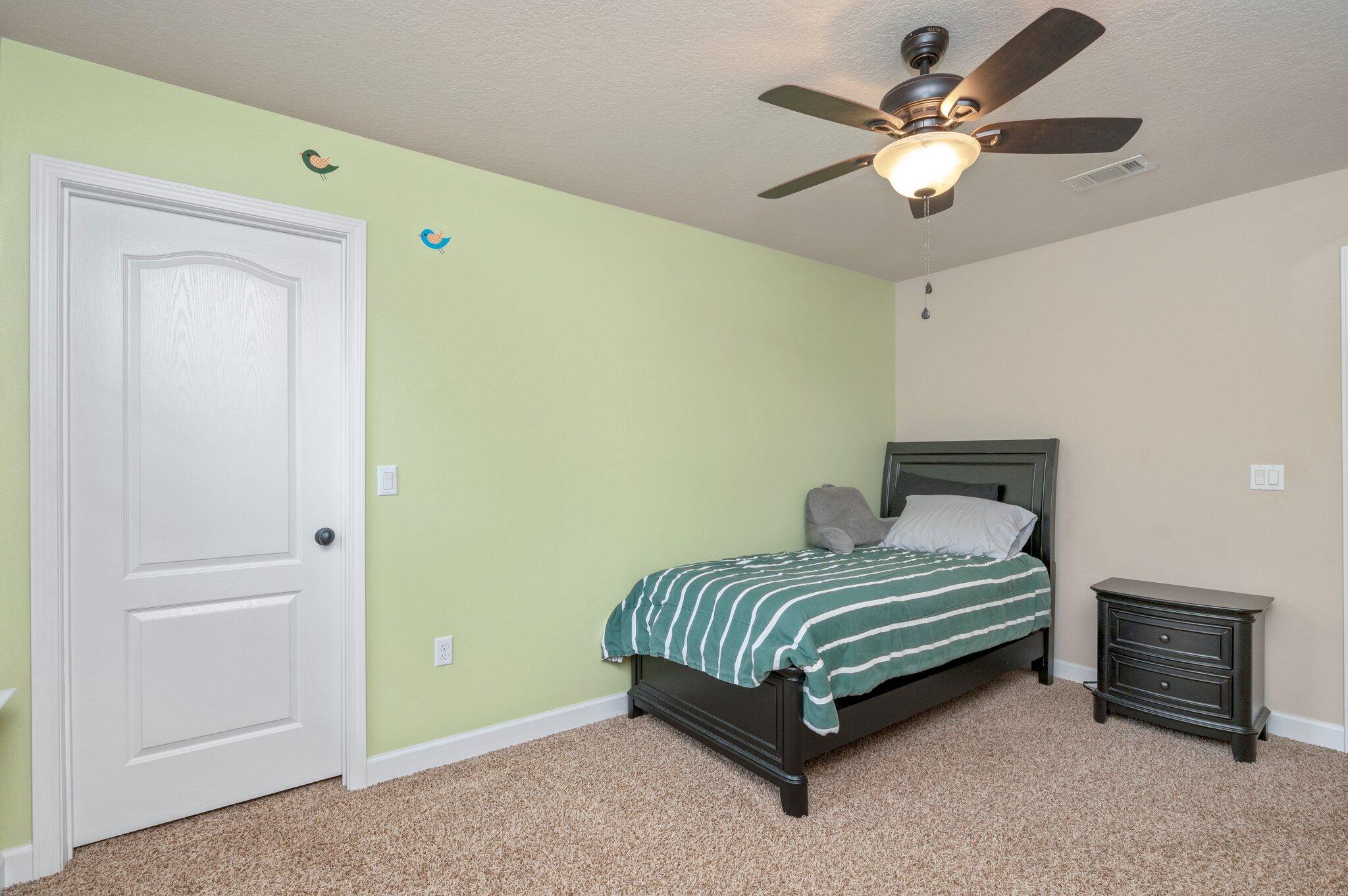 4558 Hermosa Road Crestview, FL 32539 - Photo 40 of 48 a bedroom with a bed and a chandelier