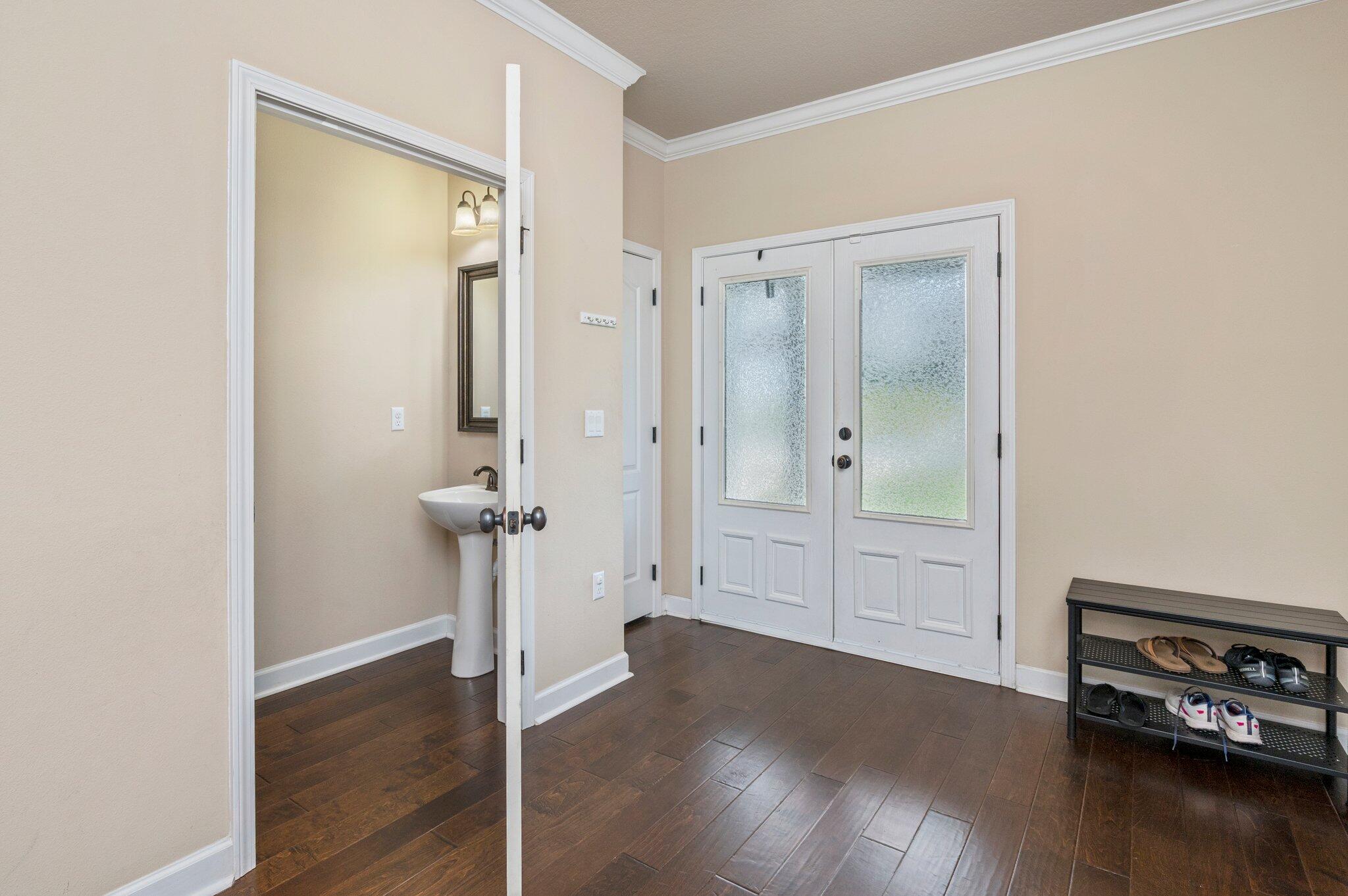4558 Hermosa Road Crestview, FL 32539 - Photo 5 of 48 a view of a hallway with wooden floor
