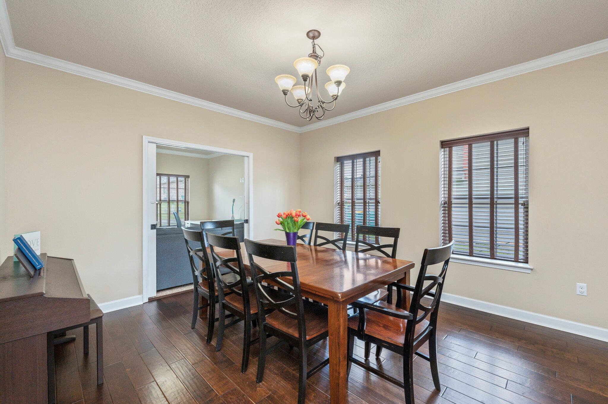 4558 Hermosa Road Crestview, FL 32539 - Photo 10 of 48 a view of a dining room with furniture window and wooden floor