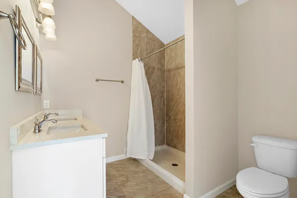 a bathroom with a sink toilet and shower